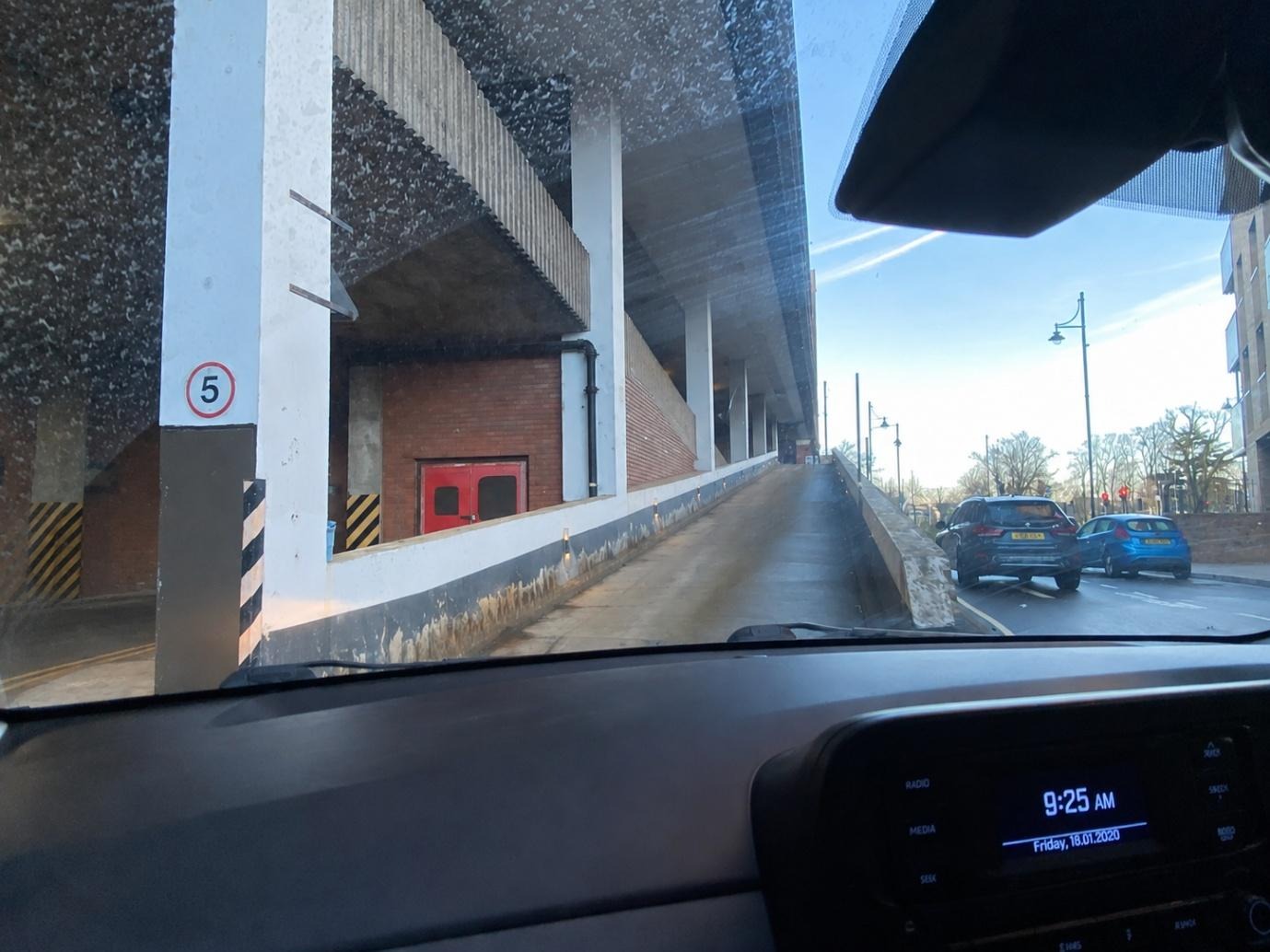 A view from inside of a car of a parking garage

Description automatically generated